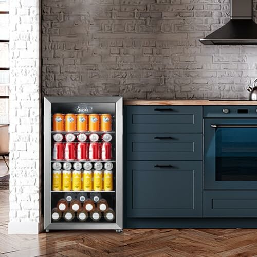 Small beverage fridge in a modern kitchen next to dark cabinets.