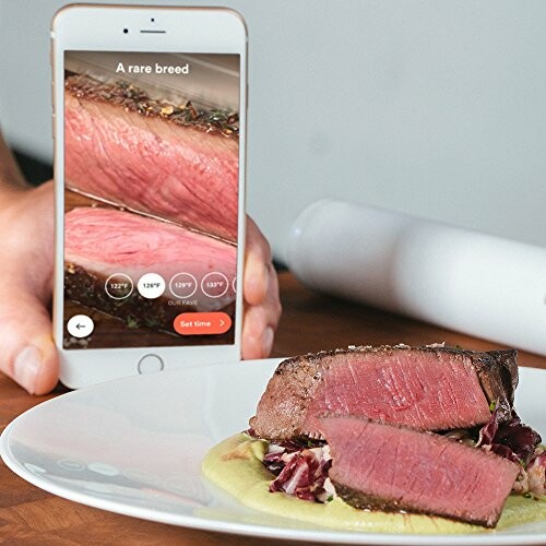 Smartphone app showing steak cooking temperatures next to a plate of steak.