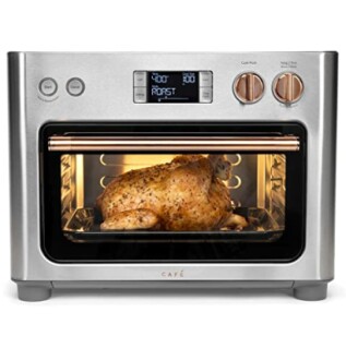 Stainless steel toaster oven with roast chicken inside